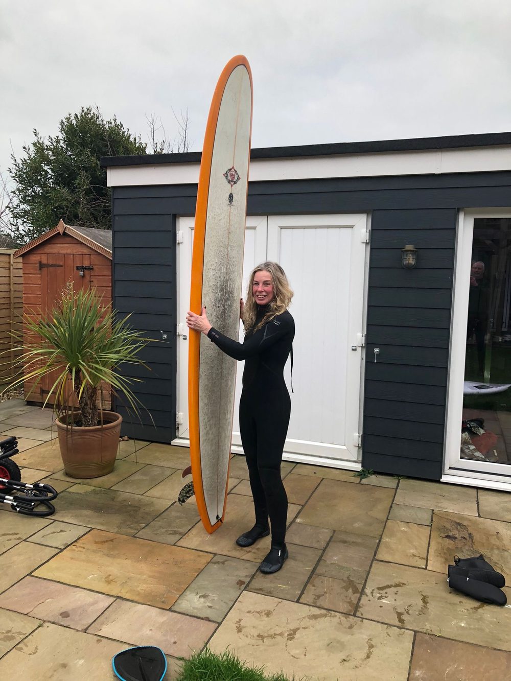 Mandy with her longboard outside her East Wittering studio