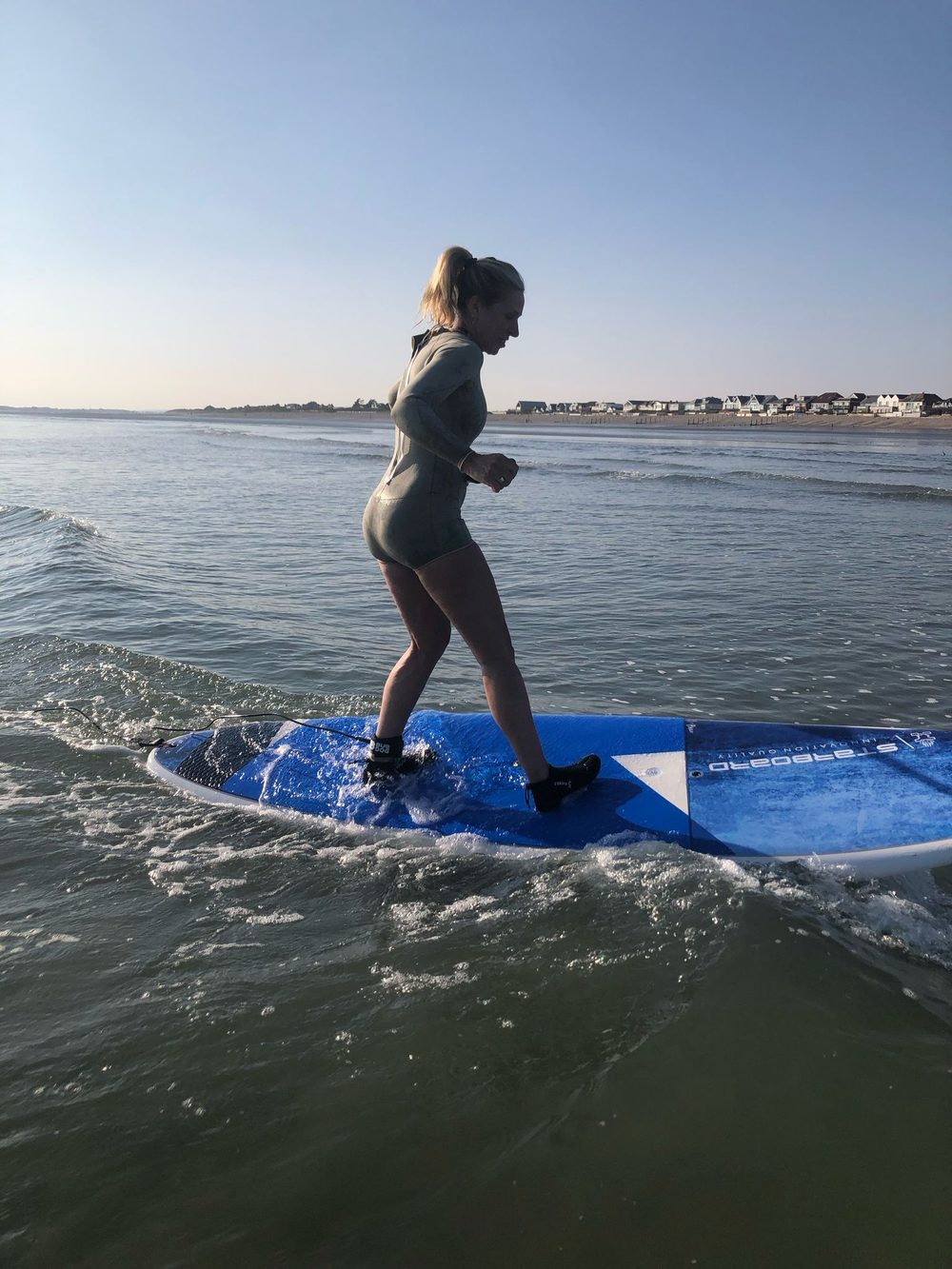 Mandy paddleboarding at sunrise in East Wittering