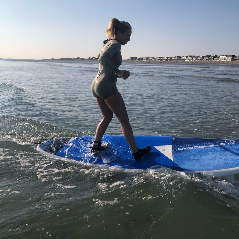 Mandy paddleboarding at sunrise